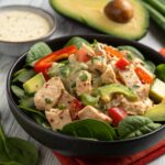 Overhead photo of keto chicken taco salad in a rustic bowl with fresh toppings